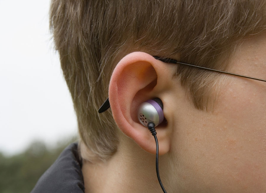silver earbud in an ear