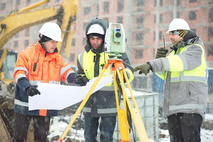 construction inspectors working outdoors in snow