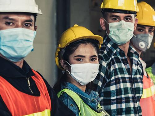 group of diverse construction workers wearing masks