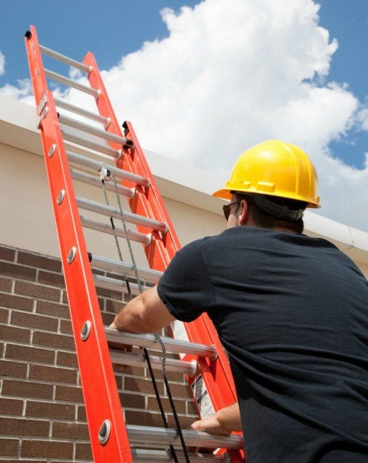 man safely climbing a ladder