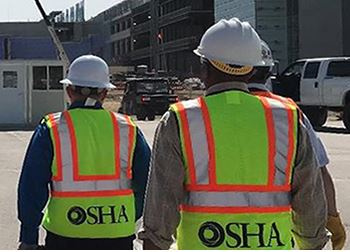 the backs of three OSHA inspectors walking